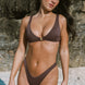 Dark haired girl wearing brown ribbed bikini top and bottoms